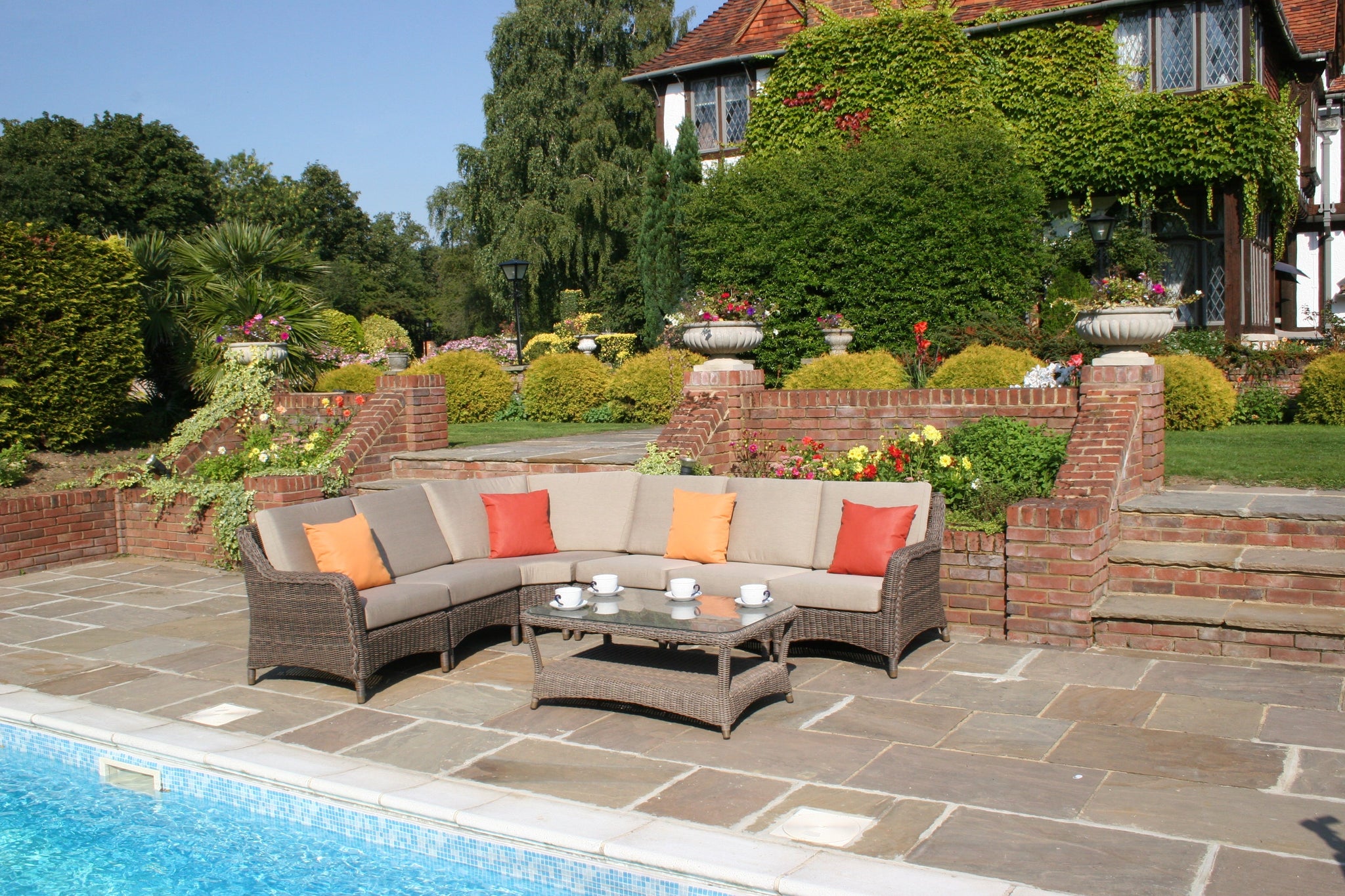 Rattan modular garden sofa on patio with rattan coffee table.